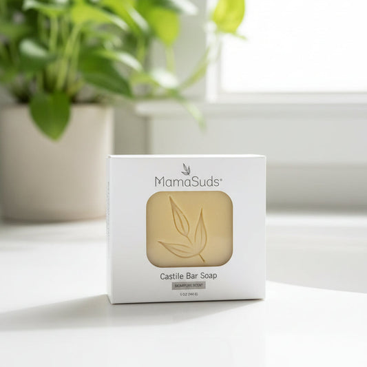 MamaSuds Castile Bar Soap packaging on a white surface with a plant in the background