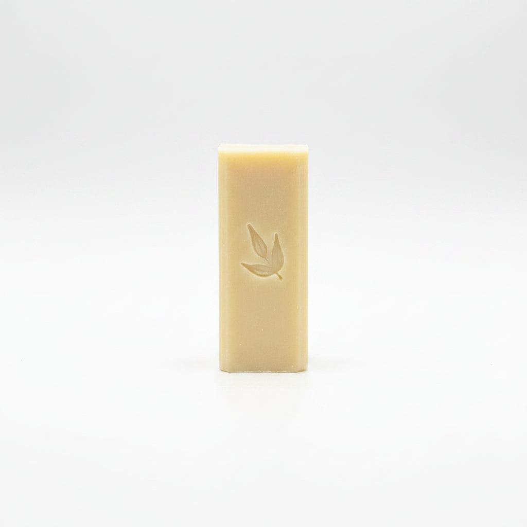 Stain stick bar with 'Mama Suds' branding leaf logo stamp on a white background.